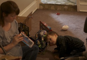 Waiting for Mom to get his gifts out of their packages.