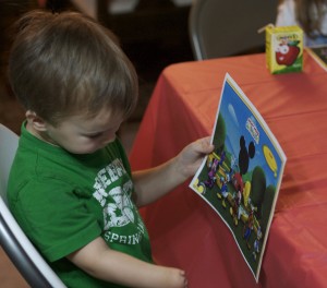 Studying his Mickey Mouse placemat.