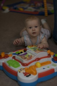 Budding musician. Brenden is not thrilled about her new interest in his toys. This one is ok, but she better leave her hands of the trains and Buzz and Woody.